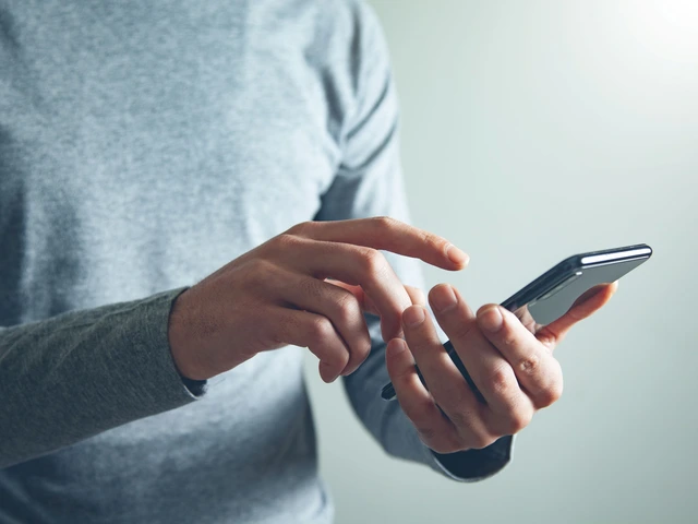 Person using a smartphone, touching the screen with one hand.